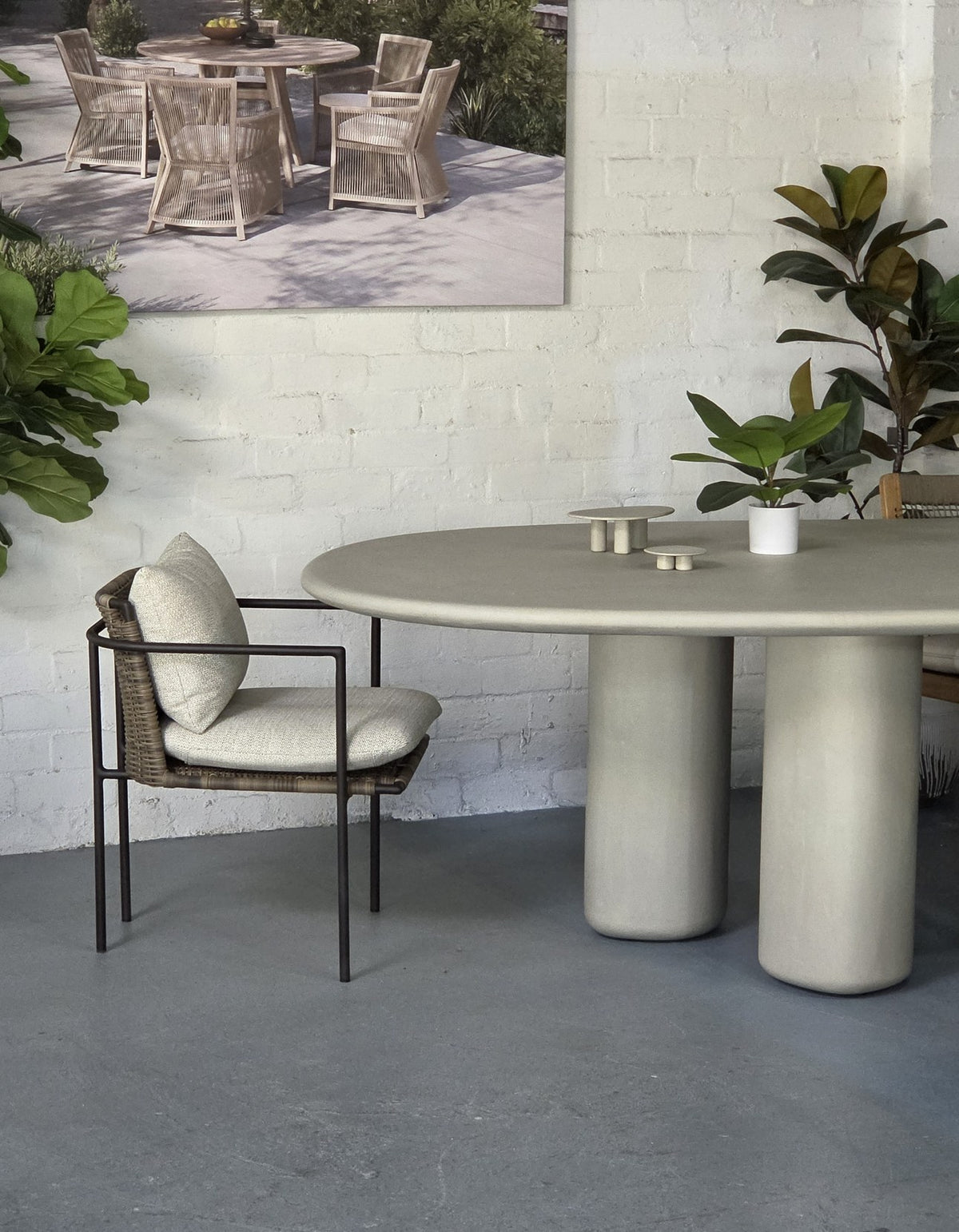 Kirra Dining Chair in Dark Earth at a round concrete dining table