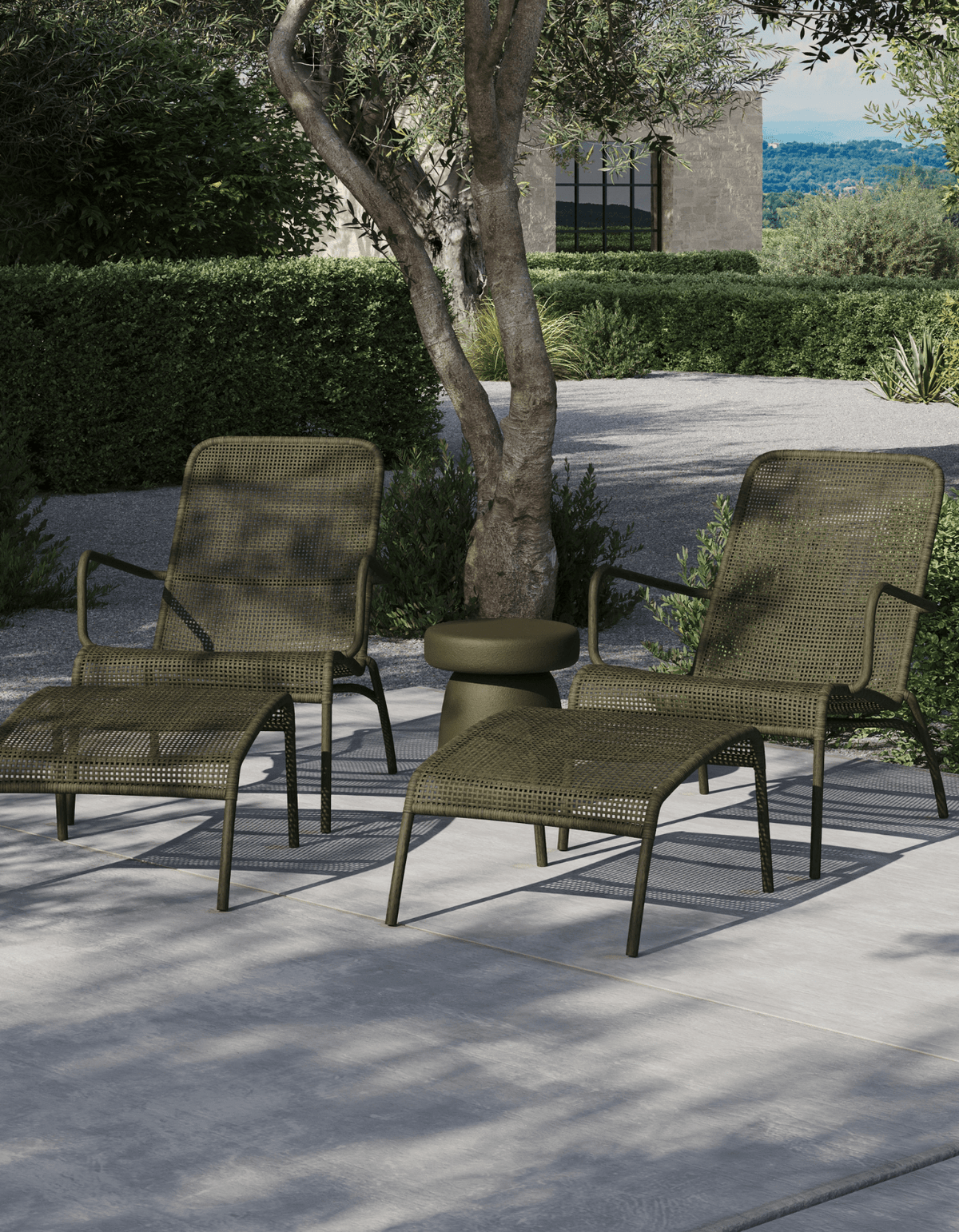 Two Ningaloo Sunlounges in Forest Green on a garden terrace under an olive tree