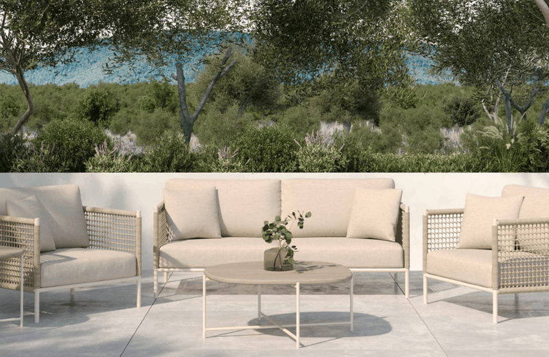 The Sissonne Outdoor Cottesole Lounge setting in Sand fabric with an Australian Bush setting in the background