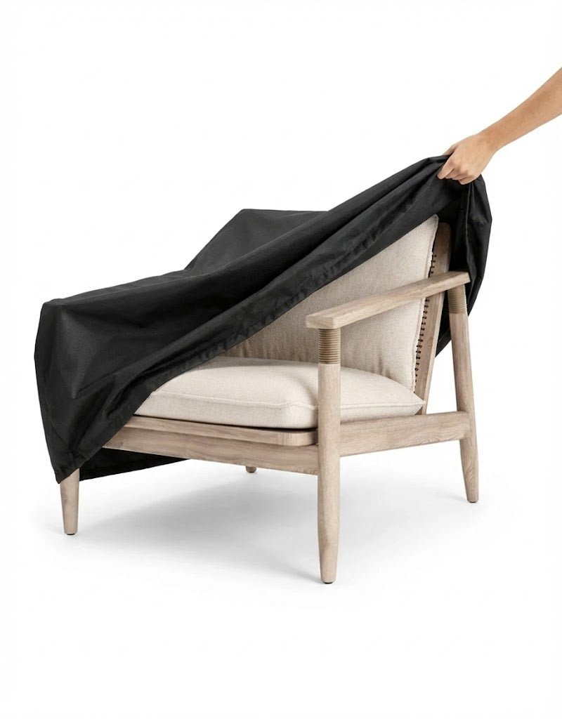 A Sissonne Outdoor Teak chair with an outdoor cover being placed on