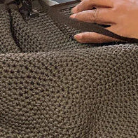Person sewing fabric with a sewing machine