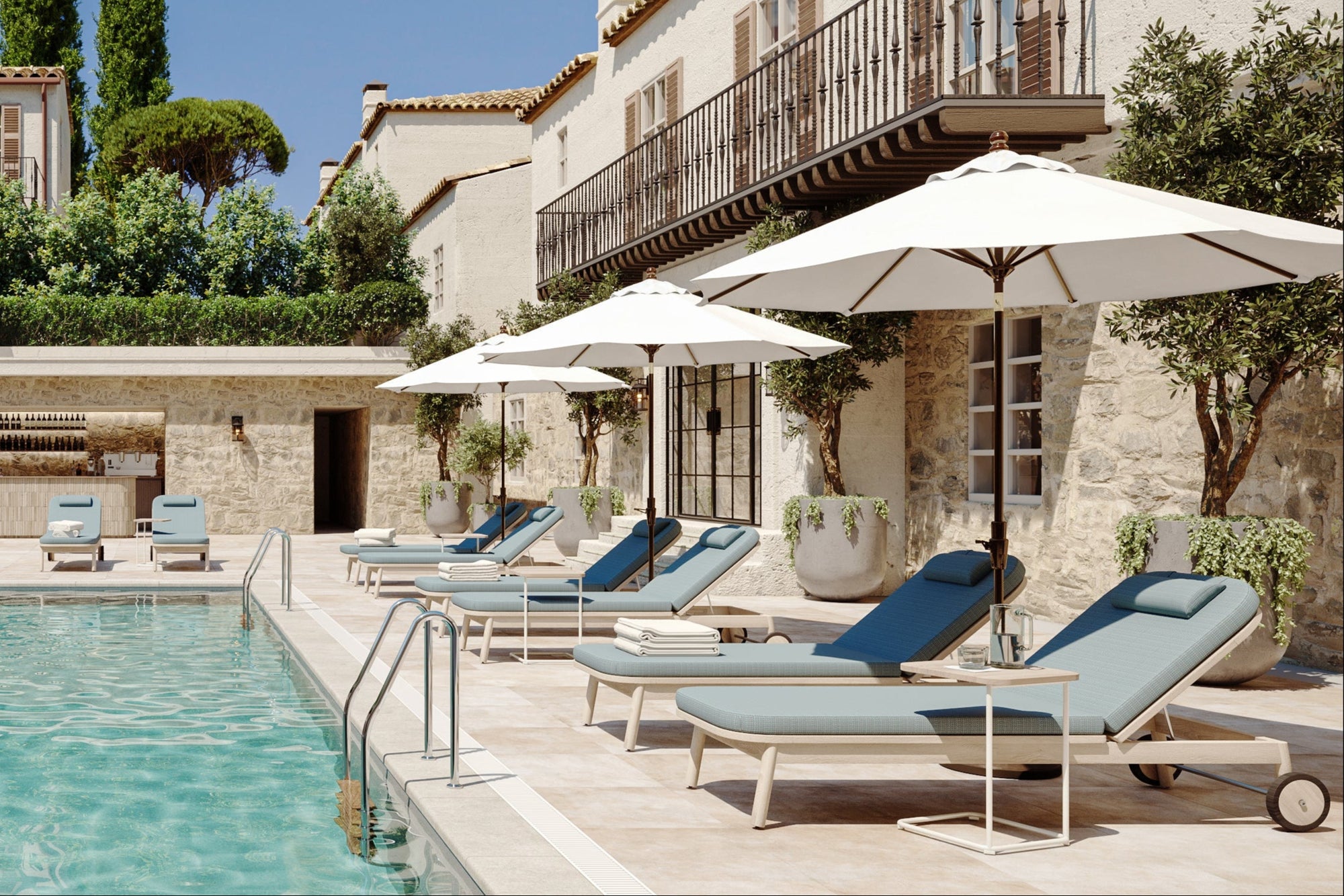 Pool area with lounge chairs and umbrellas in a luxurious setting